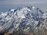 08 Nanga Parbat Diamir Face And Summit Close Up On Flight From Islamabad To Skardu The plane continues flying around Nanga Parbat with Rakhiot Peak, the East Peak, the Silver Plateau, the North Peaks, the summit above the Diamir Face and the beginning of the Mazeno Ridge on the far right.